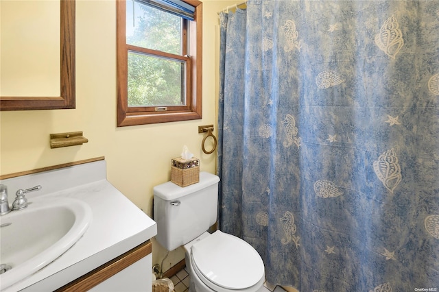 bathroom featuring tile patterned flooring, vanity, and toilet