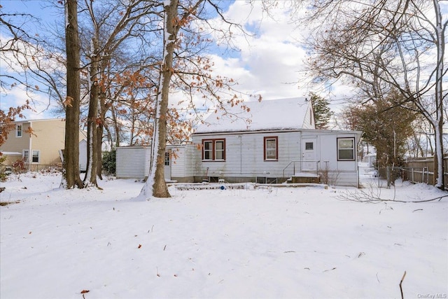 view of snow covered rear of property