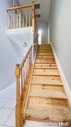 staircase with tile patterned flooring