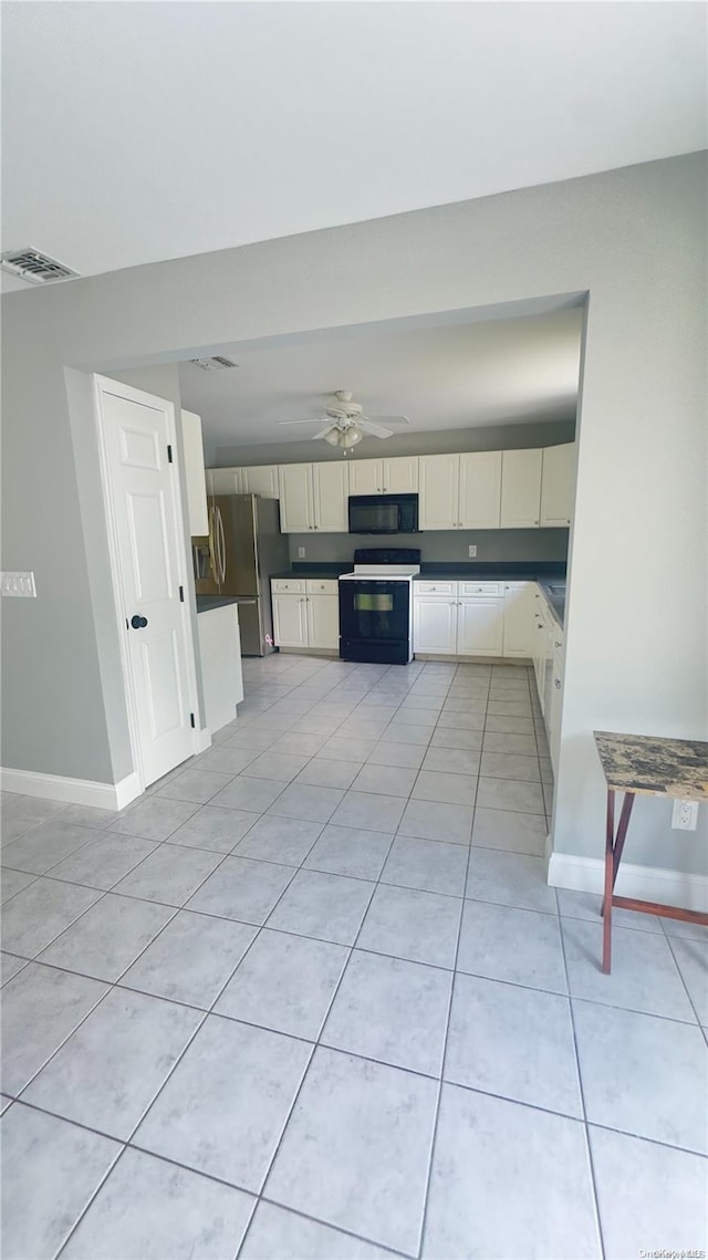 kitchen featuring black appliances, ceiling fan, light tile patterned floors, and cream cabinetry