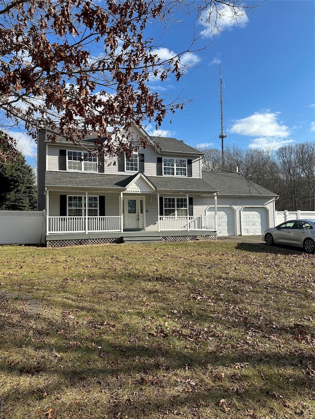 view of front of house with a porch, a garage, and a front lawn