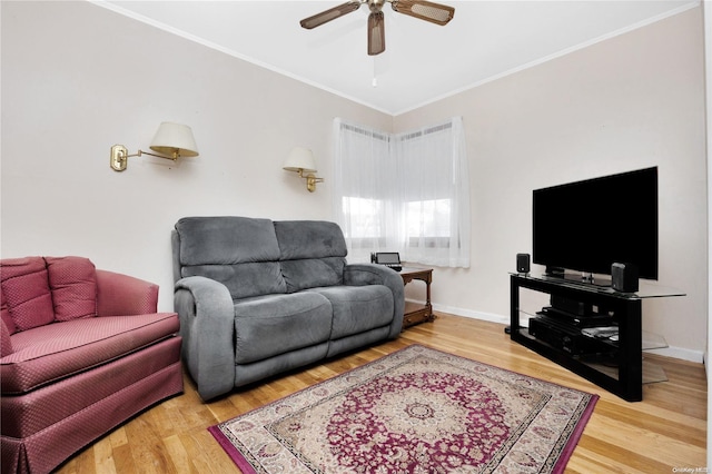 living room with wood-type flooring, ceiling fan, and ornamental molding