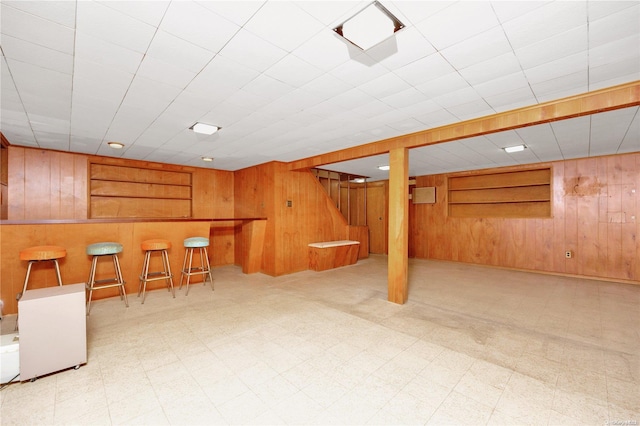 basement featuring wood walls