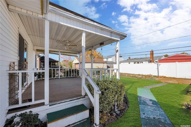 wooden deck featuring a lawn and a porch