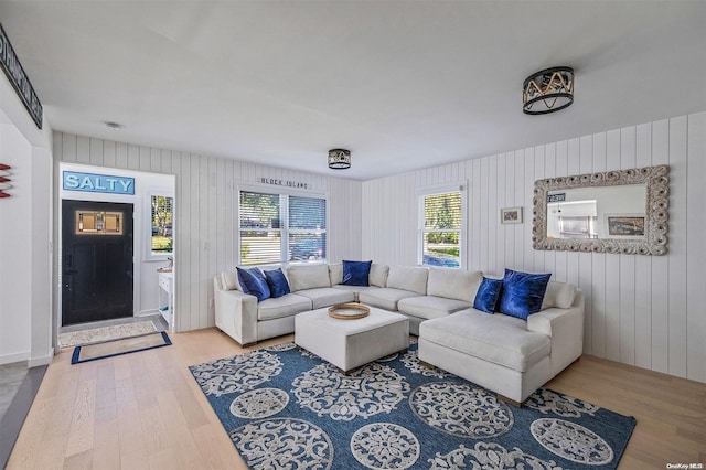 living room with hardwood / wood-style floors and wood walls