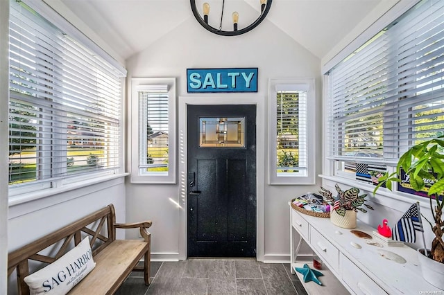 entrance foyer featuring hardwood / wood-style floors, vaulted ceiling, and a healthy amount of sunlight