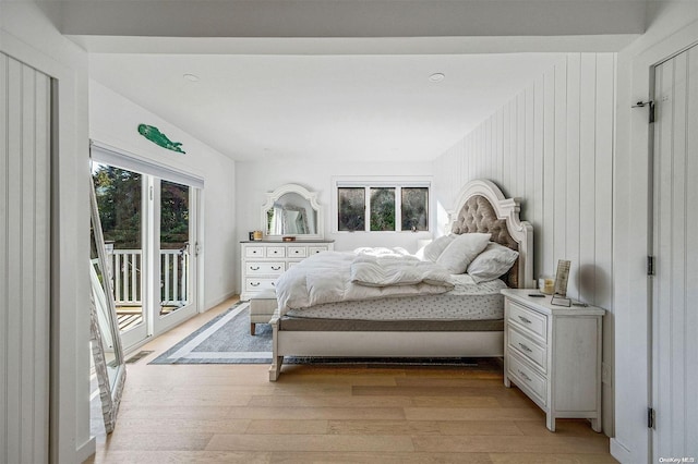 bedroom with access to outside and light wood-type flooring