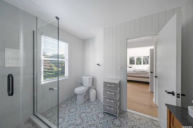 bathroom featuring walk in shower, vanity, wooden walls, hardwood / wood-style flooring, and toilet