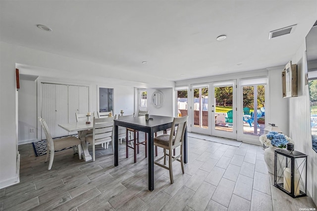 dining room with french doors and light hardwood / wood-style floors