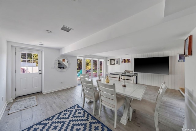 dining area featuring french doors and light wood-type flooring