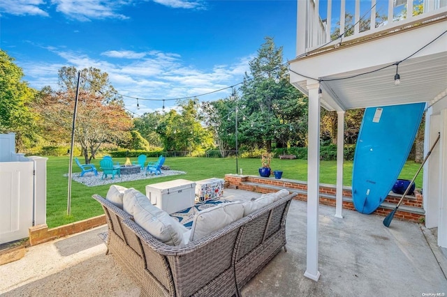 view of patio featuring a balcony and an outdoor fire pit