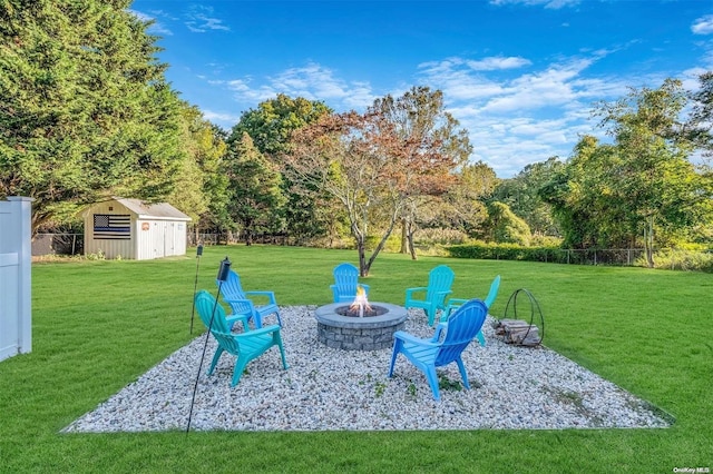 view of yard with a storage unit and an outdoor fire pit