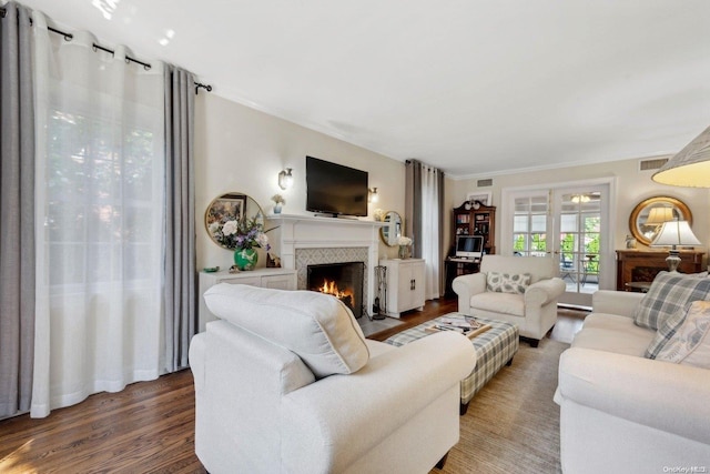 living room featuring crown molding and hardwood / wood-style flooring