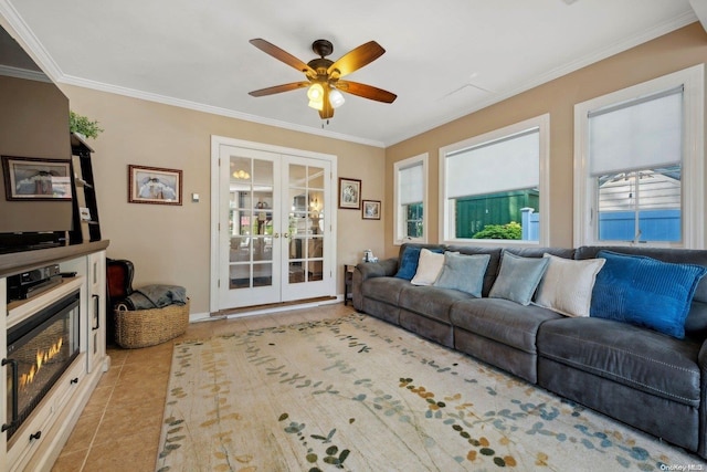 living room with french doors, light tile patterned floors, ceiling fan, and ornamental molding