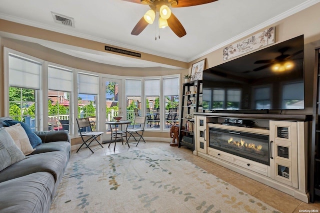 tiled living room featuring ceiling fan and ornamental molding