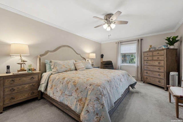 carpeted bedroom featuring ceiling fan and crown molding