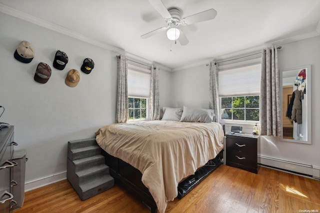 bedroom featuring light hardwood / wood-style floors, multiple windows, ornamental molding, and ceiling fan