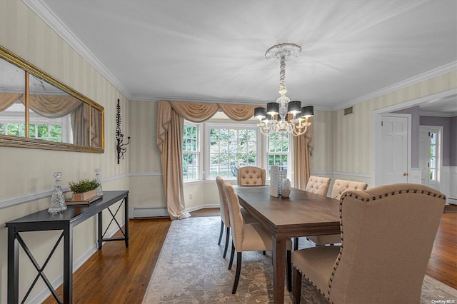 dining room featuring dark hardwood / wood-style floors, an inviting chandelier, ornamental molding, and a baseboard heating unit