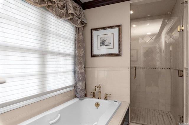 bathroom featuring ornamental molding and independent shower and bath