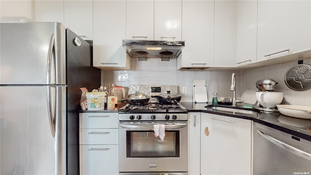 kitchen featuring range hood, a sink, stainless steel appliances, white cabinets, and dark countertops