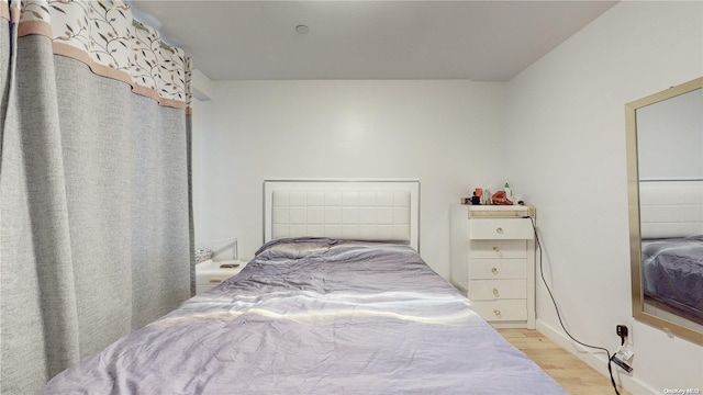 bedroom with light wood-style floors