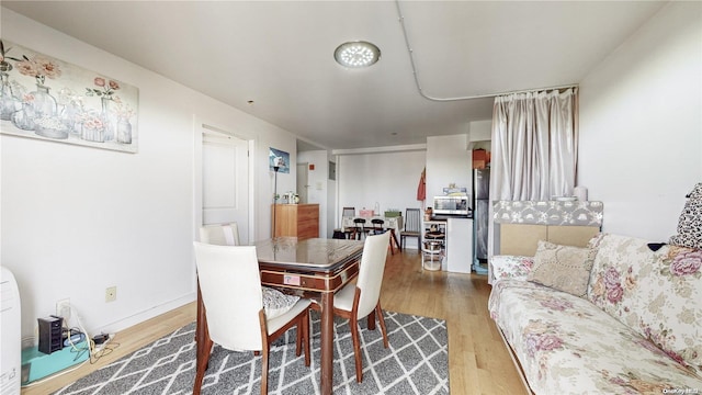 dining space with light wood finished floors