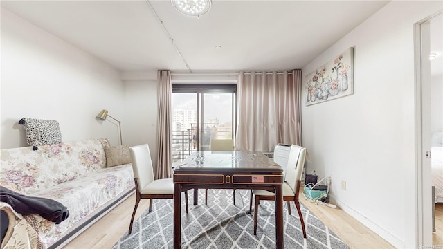 interior space with wood finished floors and baseboards