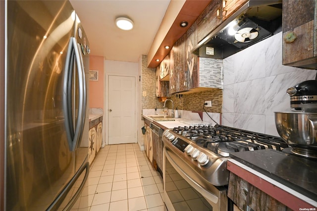 kitchen with tasteful backsplash, sink, light tile patterned floors, stainless steel appliances, and wall chimney exhaust hood