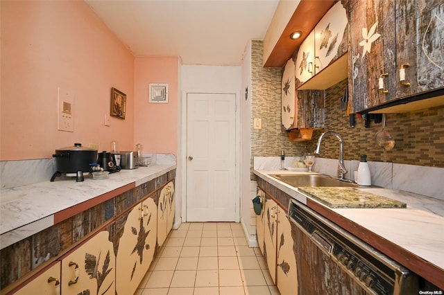 kitchen with tasteful backsplash, sink, black dishwasher, and light tile patterned flooring