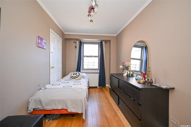 bedroom featuring crown molding and hardwood / wood-style floors