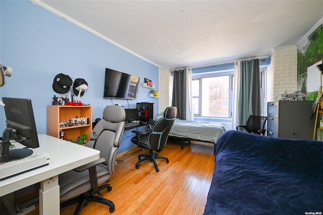 bedroom featuring wood-type flooring and ornamental molding