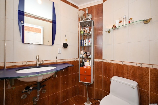 bathroom with tile walls, sink, and toilet