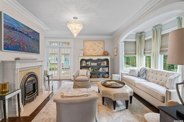 living room with hardwood / wood-style floors, a premium fireplace, ornamental molding, and a wealth of natural light