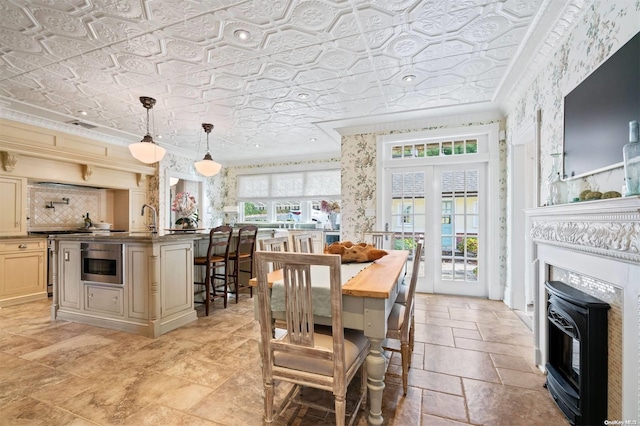 dining room featuring ornamental molding and sink