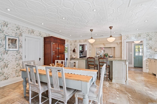 dining space with ornamental molding