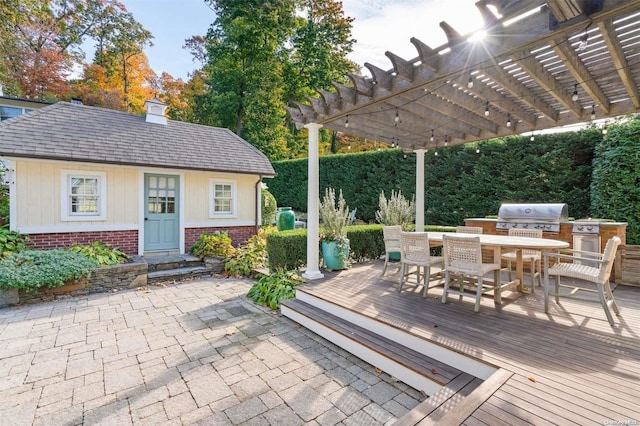 exterior space featuring a pergola, grilling area, and exterior kitchen