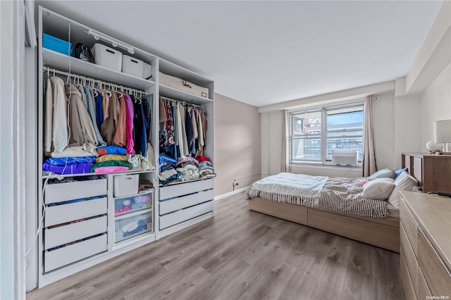 bedroom featuring a closet, cooling unit, and light wood-type flooring