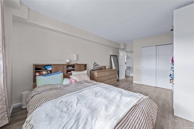 bedroom featuring hardwood / wood-style flooring and a closet