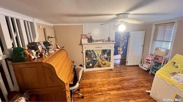 office area featuring ceiling fan, wood-type flooring, and ornamental molding