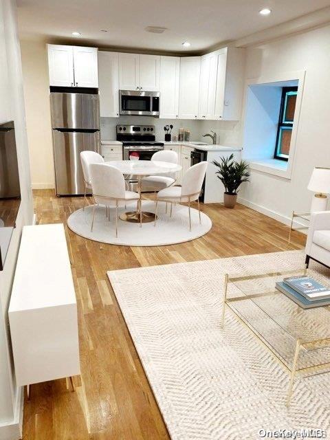 living room featuring light hardwood / wood-style floors and sink