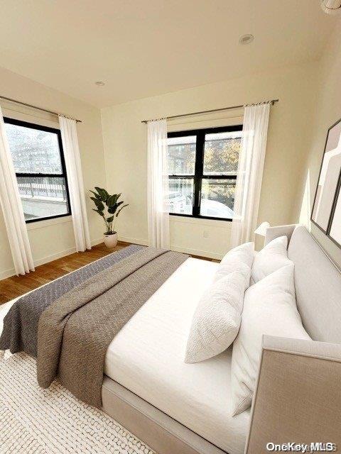 bedroom featuring light hardwood / wood-style floors and multiple windows