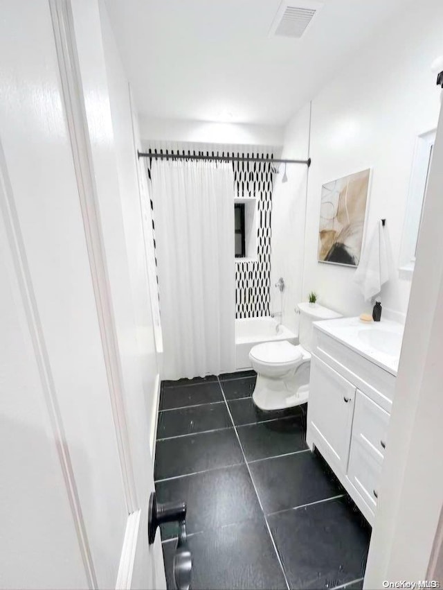 full bathroom with tile patterned floors, vanity, shower / tub combo, and toilet