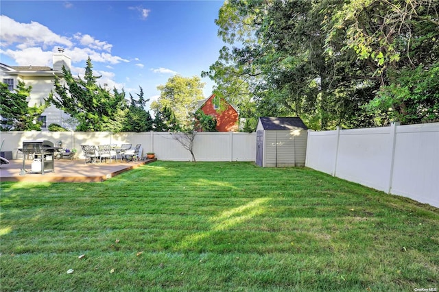 view of yard featuring a shed and a deck