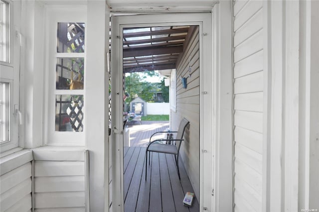 doorway to outside featuring hardwood / wood-style floors, plenty of natural light, and wood walls