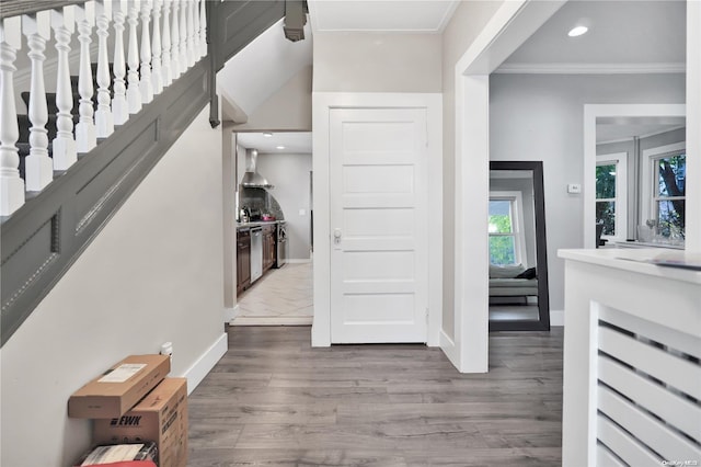 interior space with hardwood / wood-style floors and ornamental molding