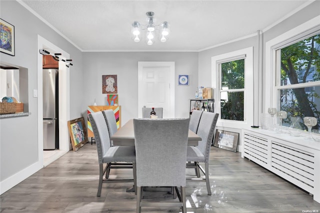 dining area with a textured ceiling, dark hardwood / wood-style floors, and crown molding