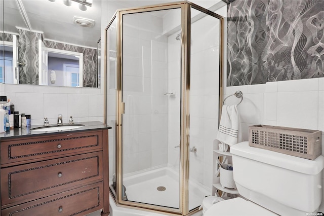 bathroom with vanity, decorative backsplash, toilet, tile walls, and an enclosed shower