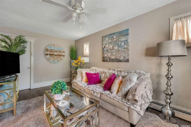 living room featuring hardwood / wood-style flooring, baseboard heating, and ceiling fan