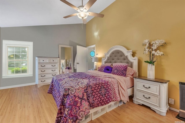 bedroom featuring ceiling fan, high vaulted ceiling, and light hardwood / wood-style floors