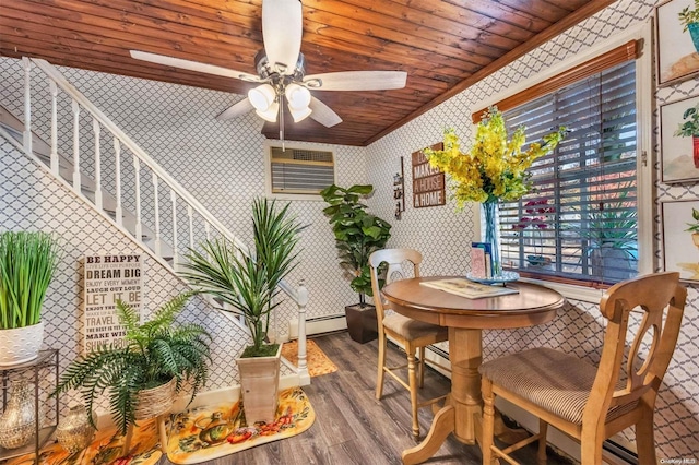dining room with hardwood / wood-style floors, crown molding, ceiling fan, baseboard heating, and wood ceiling